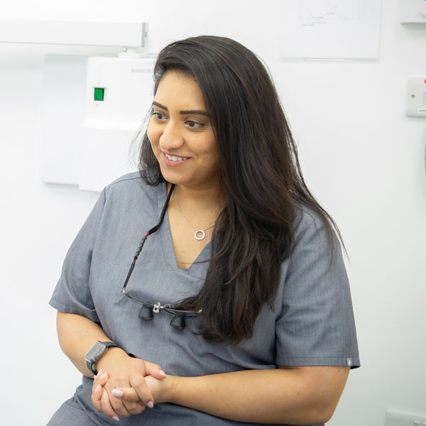 dentist wearing grey scrubs