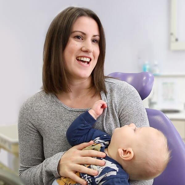 women holding a baby in a dental practice